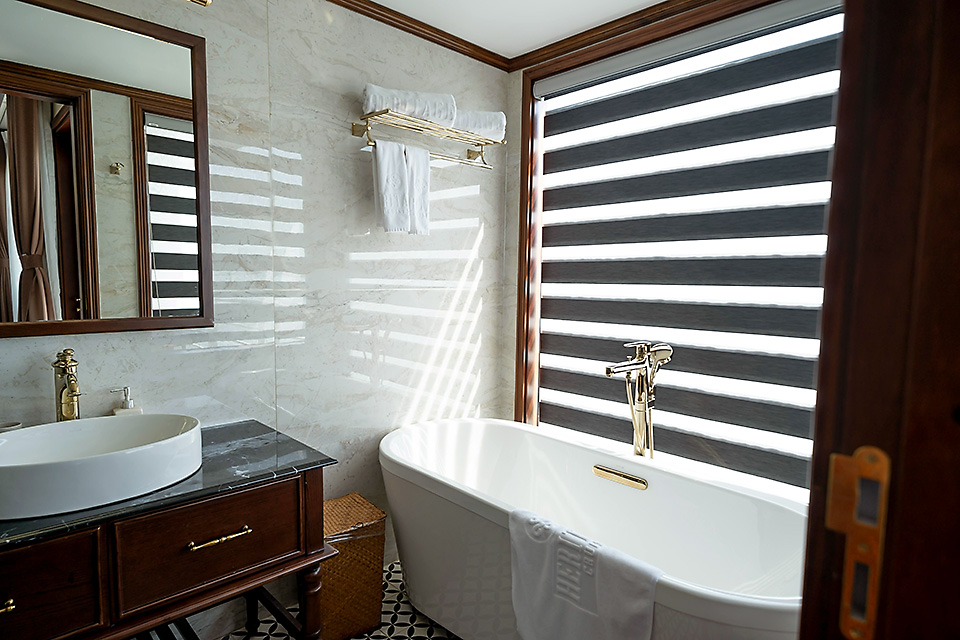 Bright, spa-inspired bathroom with natural light, modern tub, and calming textures — perfect for wellness or boutique stay website templates.
